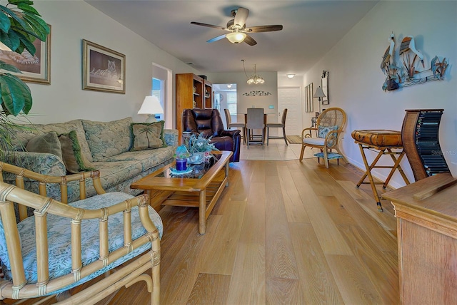 living room featuring ceiling fan and light hardwood / wood-style floors