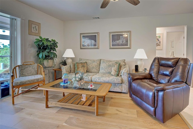 living room featuring ceiling fan and light wood-type flooring