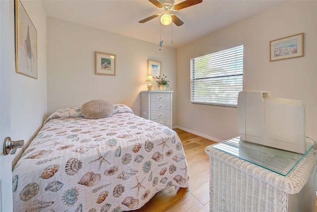 bedroom with ceiling fan and light hardwood / wood-style floors