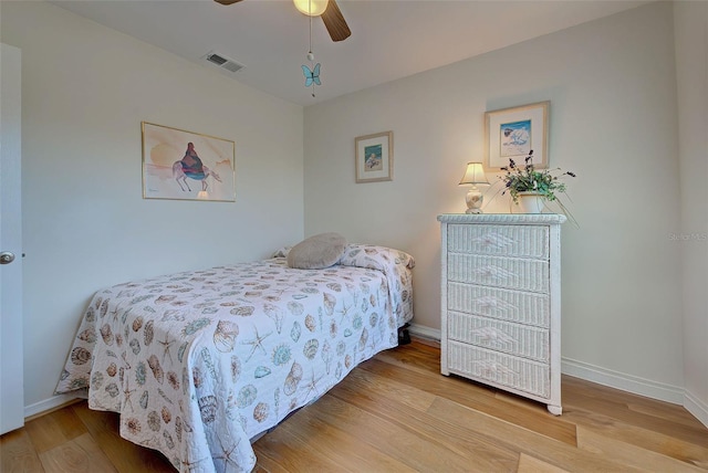 bedroom featuring hardwood / wood-style flooring and ceiling fan