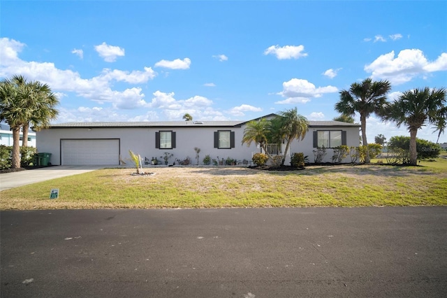 single story home with a garage and a front lawn