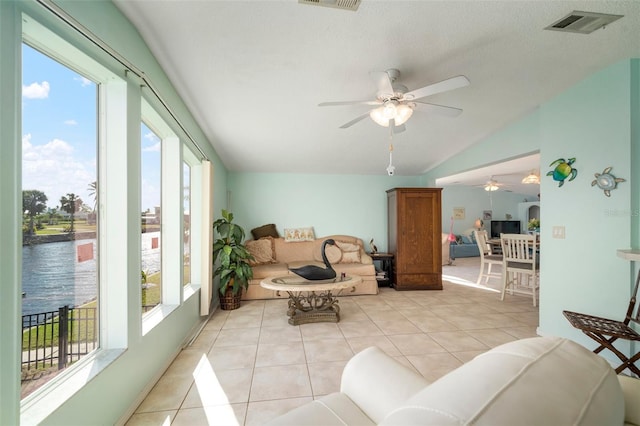 interior space featuring plenty of natural light, ceiling fan, a water view, and lofted ceiling