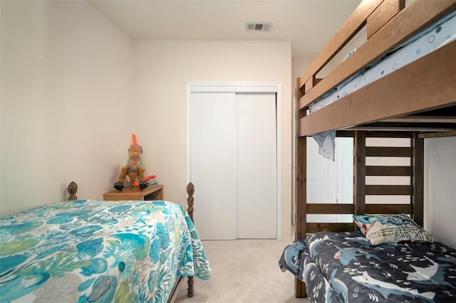 bedroom with light colored carpet and a closet