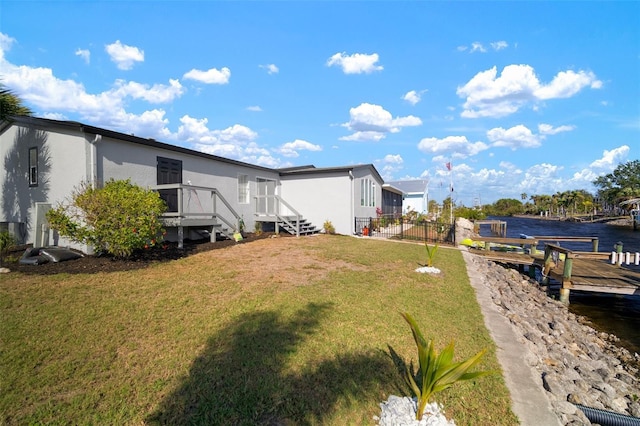 view of yard with a deck with water view