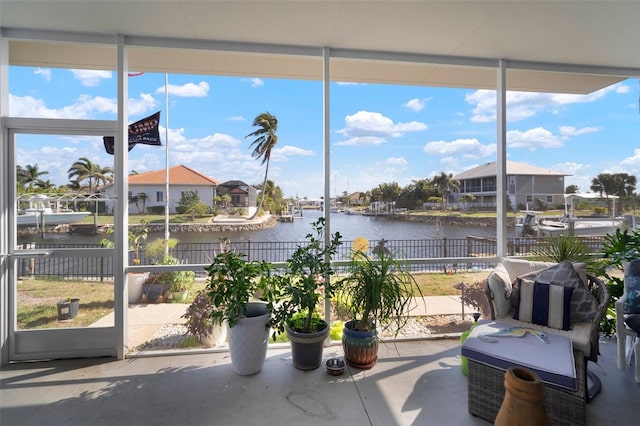 sunroom / solarium with a water view