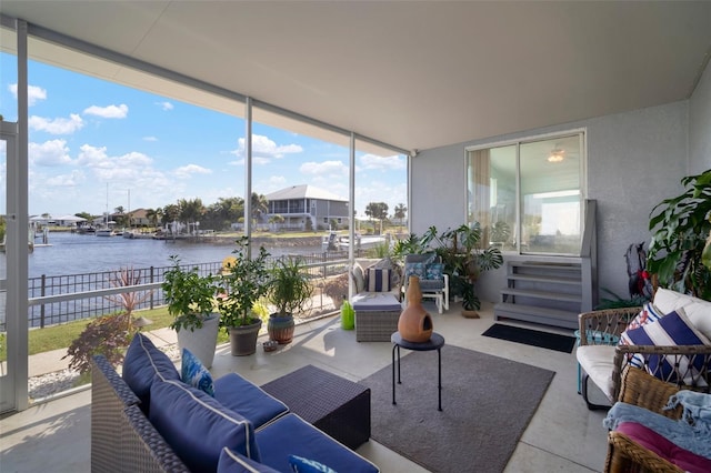 sunroom with plenty of natural light and a water view