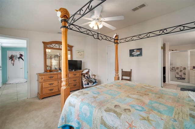 carpeted bedroom featuring ceiling fan and ensuite bath