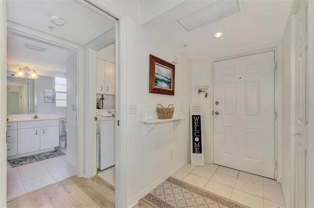 entryway featuring sink and light tile patterned flooring