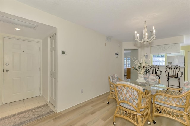 dining space featuring light tile patterned floors and a chandelier