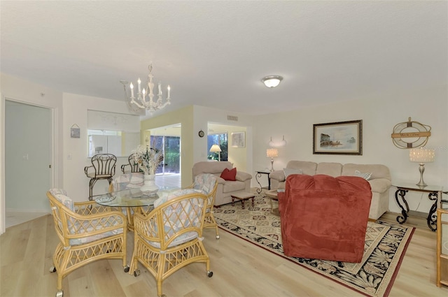 dining area featuring a chandelier and light hardwood / wood-style flooring