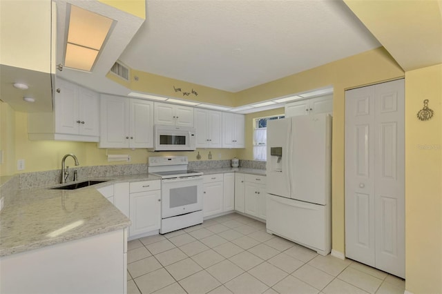 kitchen with white cabinets, white appliances, sink, and light tile patterned floors