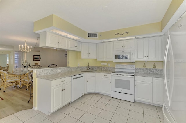 kitchen with white appliances, sink, kitchen peninsula, light tile patterned floors, and white cabinetry