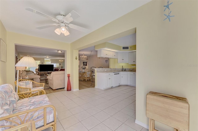 living room featuring sink, ceiling fan with notable chandelier, and light tile patterned flooring