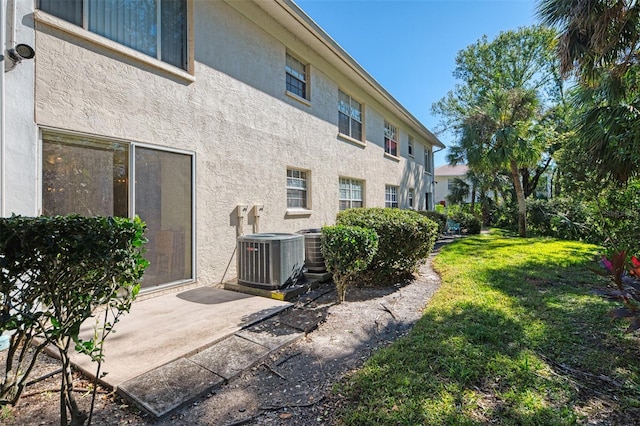 exterior space featuring a yard and cooling unit