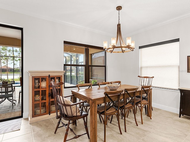 tiled dining room featuring ornamental molding and a chandelier