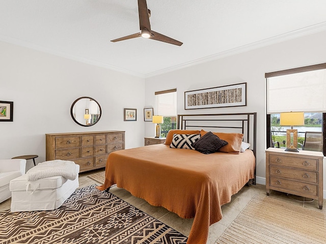 tiled bedroom with ceiling fan and crown molding