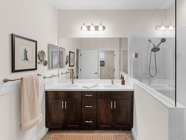 bathroom with a shower, vanity, and tile patterned floors