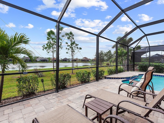 view of patio featuring a lanai and a water view