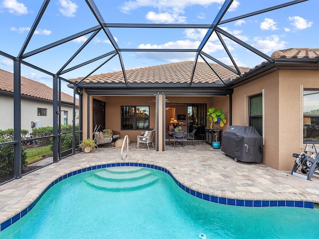 view of pool featuring a lanai, a grill, and a patio