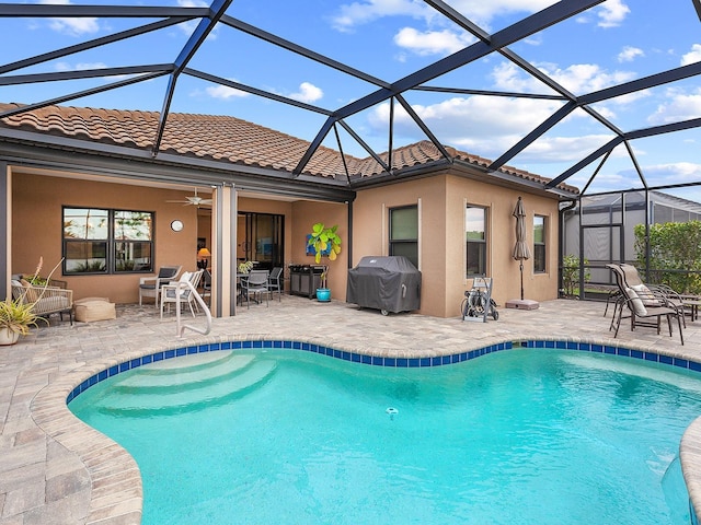 view of swimming pool with a patio area, grilling area, a lanai, and ceiling fan