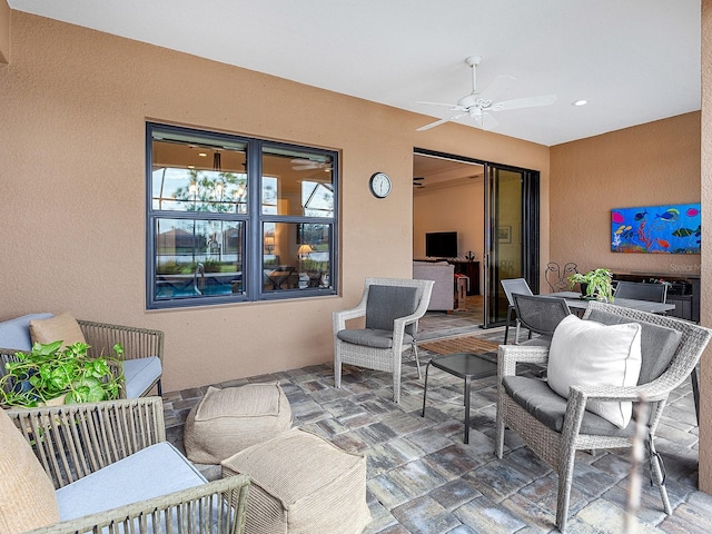 view of patio / terrace with ceiling fan and an outdoor hangout area