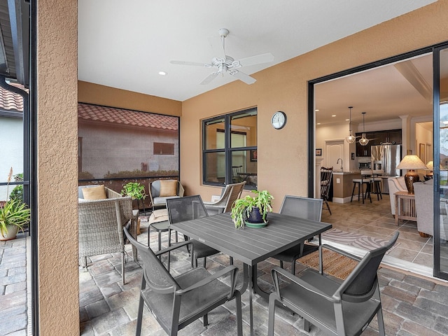 view of patio / terrace with ceiling fan and sink