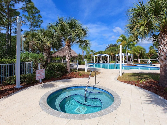 view of pool featuring a gazebo and a hot tub