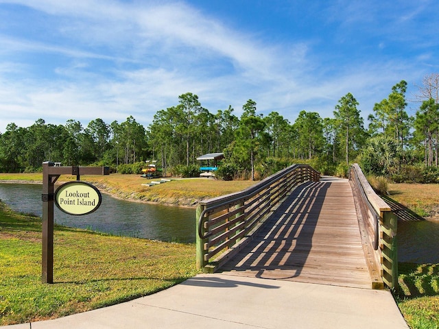 view of home's community with a yard and a water view