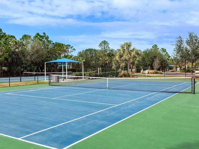 view of tennis court featuring basketball hoop