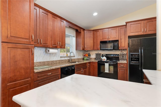 kitchen featuring light stone countertops, sink, tasteful backsplash, lofted ceiling, and black appliances