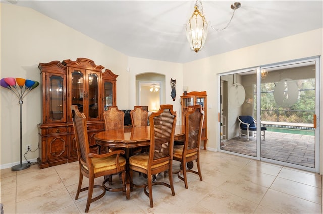 dining room featuring light tile patterned flooring and an inviting chandelier