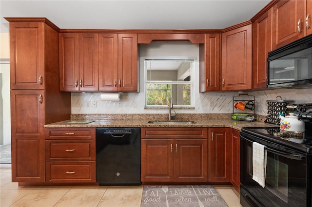 kitchen with black appliances, light tile patterned flooring, light stone countertops, and sink