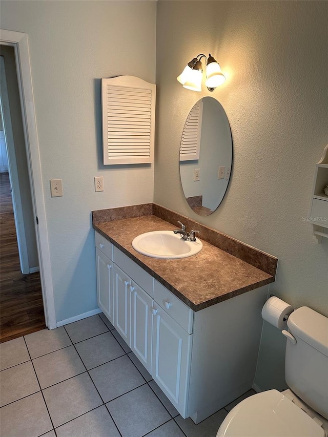 bathroom with tile patterned floors, vanity, and toilet