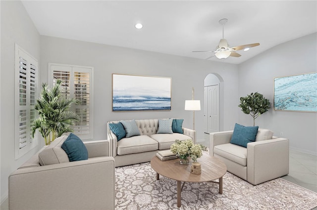 tiled living room featuring lofted ceiling and ceiling fan