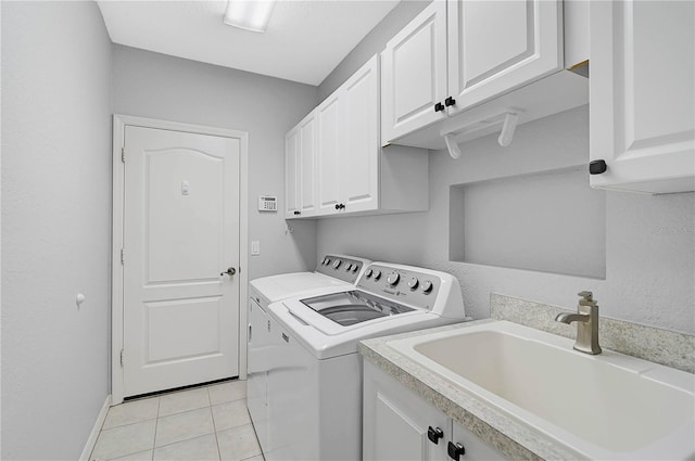 4575 Cancello Grande Ave, Venice, FL 34293 - laundry area featuring cabinets, sink, light tile patterned floors, and washer and clothes dryer