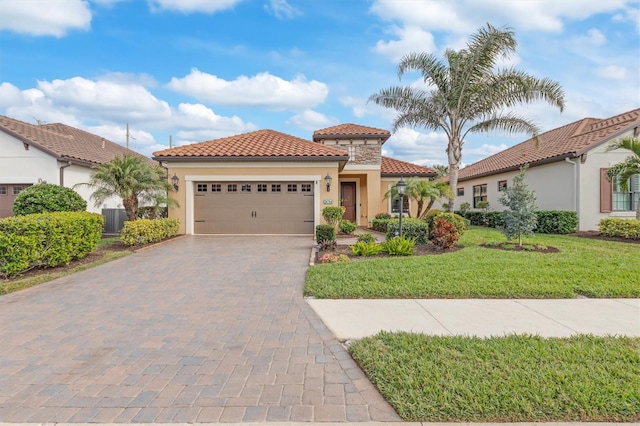 mediterranean / spanish-style house featuring central AC unit, a garage, and a front yard