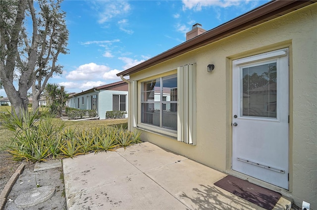 property entrance featuring a patio