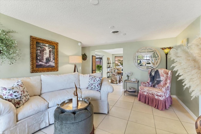 tiled living room with a textured ceiling