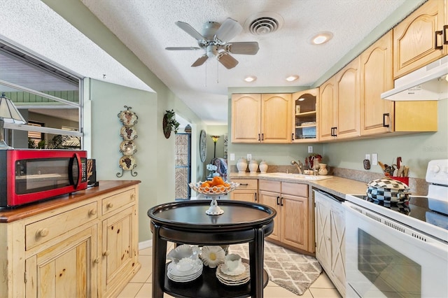 kitchen featuring white range with electric cooktop, light tile patterned floors, sink, and light brown cabinets