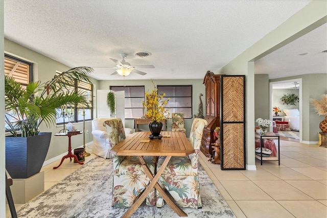 dining room featuring light tile patterned floors, a textured ceiling, and ceiling fan