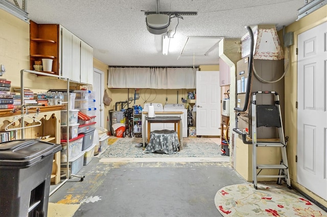 garage with independent washer and dryer and a garage door opener