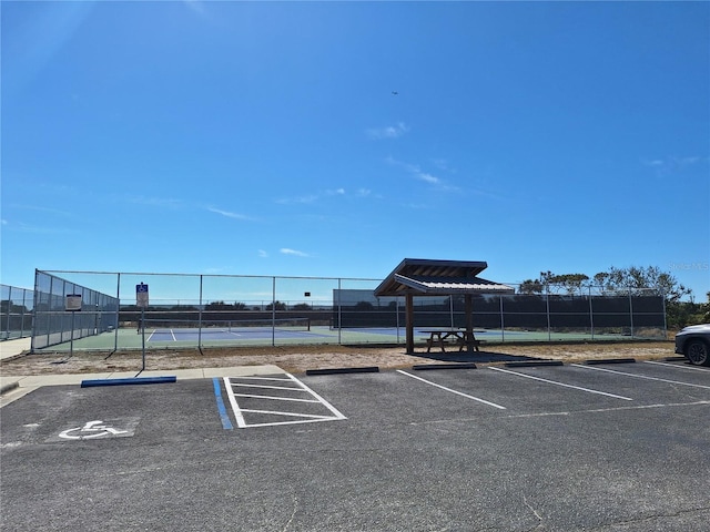 view of parking with tennis court