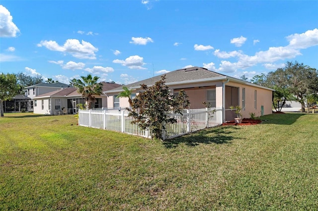 rear view of house featuring a yard