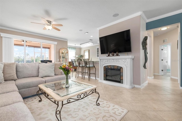 tiled living room featuring ceiling fan and crown molding