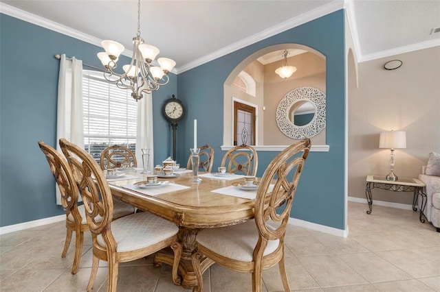 tiled dining area featuring an inviting chandelier and ornamental molding