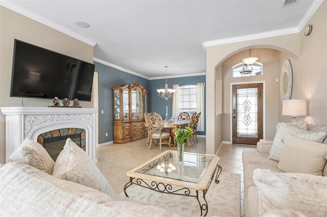 tiled living room with ornamental molding and a chandelier