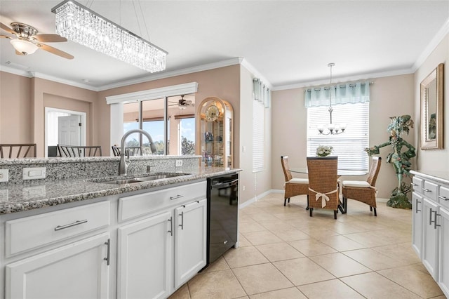 kitchen featuring light stone countertops, white cabinets, hanging light fixtures, and black dishwasher