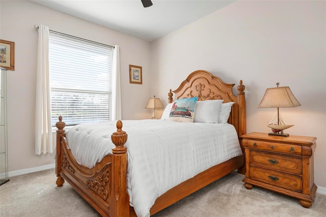 carpeted bedroom featuring ceiling fan and multiple windows