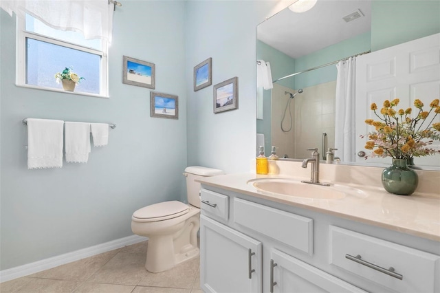 bathroom with tile patterned flooring, a shower with curtain, vanity, and toilet