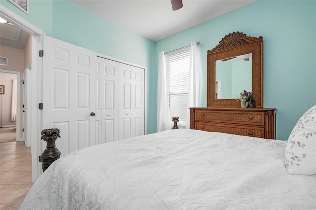 bedroom with ceiling fan, light tile patterned flooring, and a closet